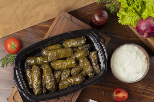 Yarpaq dolmasi, yaprak sarmasi, green grape leaves stuffed with meat takeaway. image